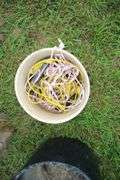 (2) Saw Horses, Cable, (2) Flower Pots, (4) Pieces of 4 Inch Drain Pipe, and Misc. Rope Pieces