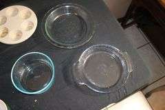 Pyrex Glass Dishes with Lids, (2) Anchor Hocking Glass Baking Dishes, Muffin Tray, Igloo Container, and Misc.