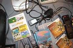 Daewoo VHS Player, Arris HDMI Box, Sony Blu Ray Player, VHS Player, TV Remotes, Candles, Kinyo VHS Tape Player, Protron DVD Player, Iron, and Misc.