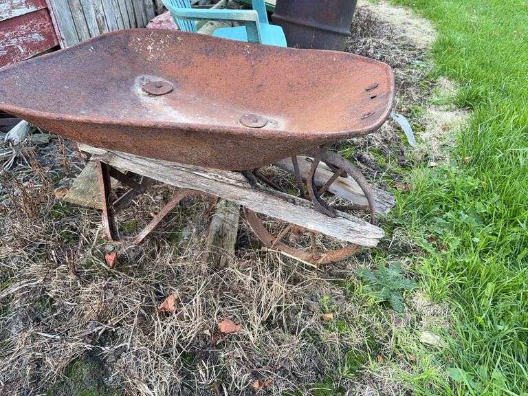 Vintage garden wheel barrel and plastic chair image