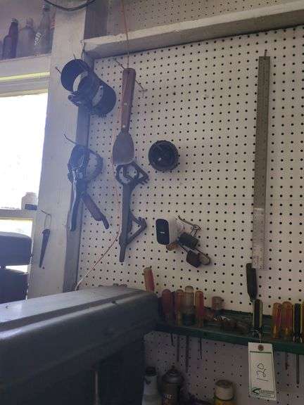 Screw drivers, contents of small shelf, hanging tools