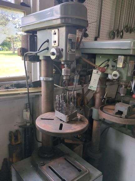 Bench model drill press includes cabinet and contents
