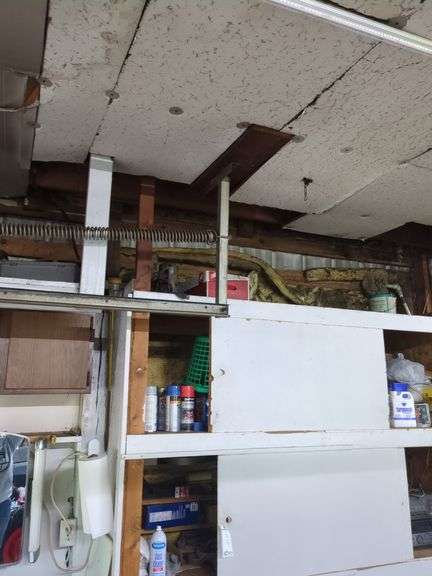Contents of top shelf, sprayer, metal tool box