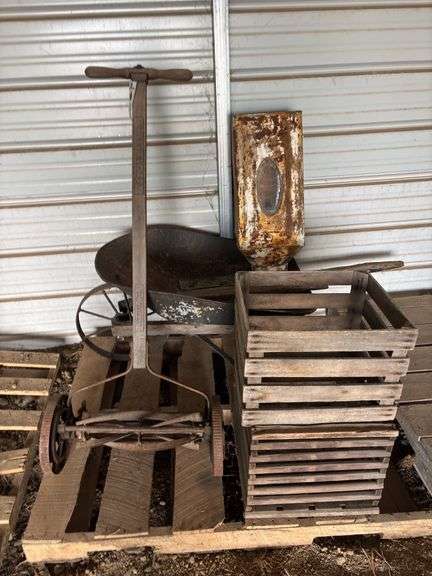 Vintage wheel barrow, push mower, flower bin, and wooden crates, bldg:locked image