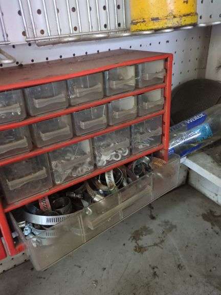 Contents of small shelf, nuts and bolts organizer, lube cans, oil can, belts