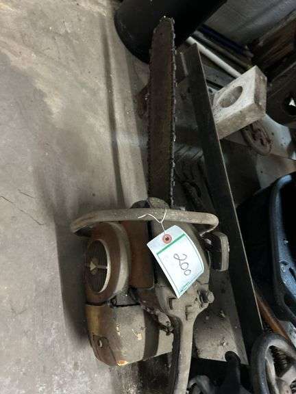 Vintage chainsaw and wheel