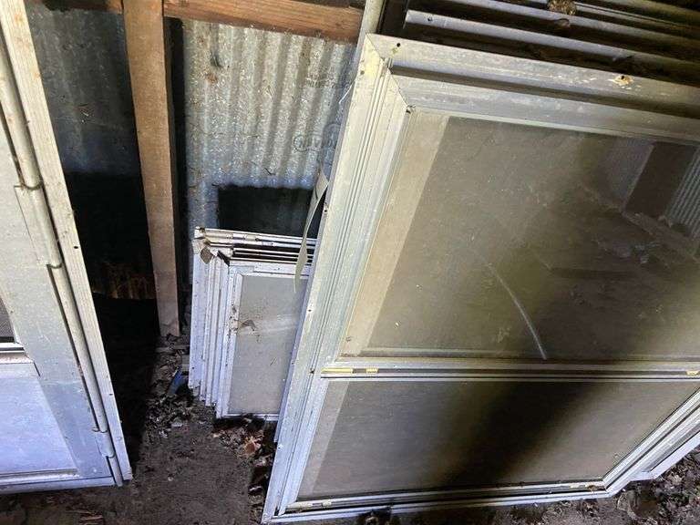 Assorted storm windows and door