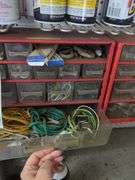 Contents of small shelf, nuts and bolts organizer, lube cans, oil can, belts