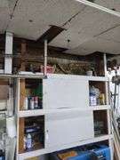 Contents of top shelf, sprayer, metal tool box