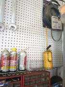 Contents of small shelf, nuts and bolts organizer, lube cans, oil can, belts