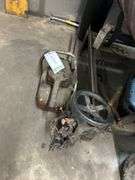 Vintage chainsaw and wheel