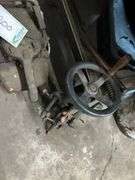 Vintage chainsaw and wheel