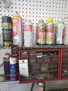 Contents of small shelf, nuts and bolts organizer, lube cans, oil can, belts
