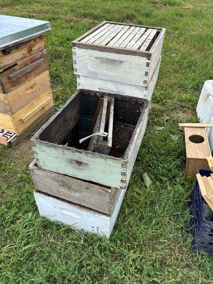 Pile of bee boxes and frames, row:10 image