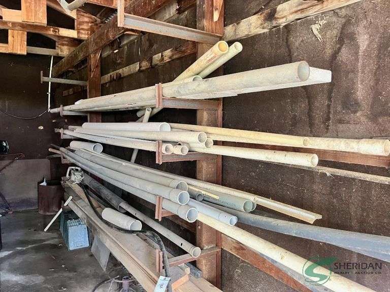 Contents on wall in garage, PVC pipe, lumber and misc. image