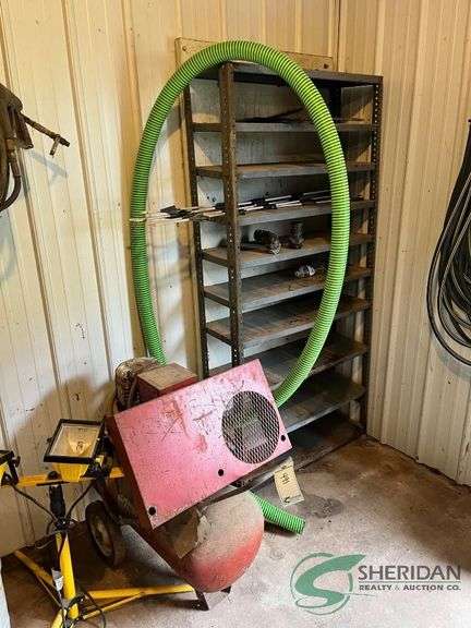 Shop light, metal shelf, hose, and old air compressor and milk can image