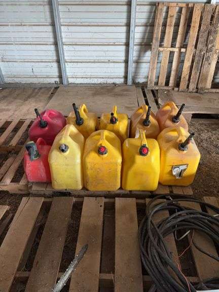 (8) 5 gallon diesel fuel cans, (1) 5 gallon gas can, & (1) 2 gallon gas can, bldg:locked image