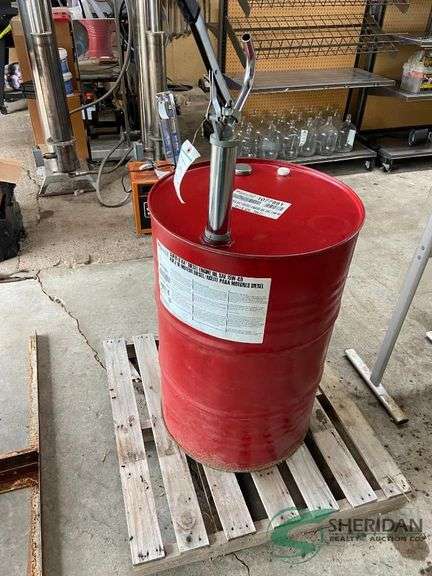 Almost full barrel of 15W-40 oil with hand pump image