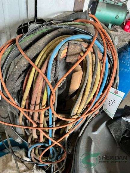 Various Extension Cords and some hydraulic hoses image