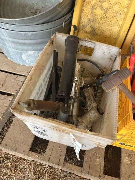 Tote of grease guns, bldg:green image