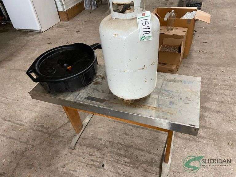 Propane tank, table, and oil catch basin image