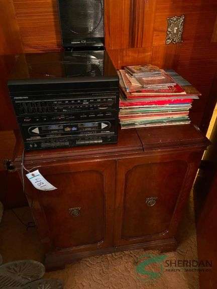 Record player with cabinet and records image