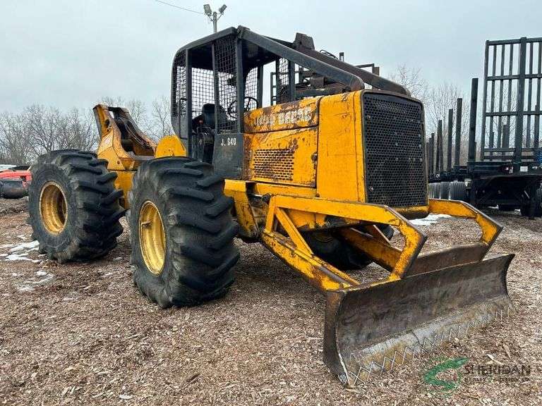 John Deere 640 log skidder with flat tire image