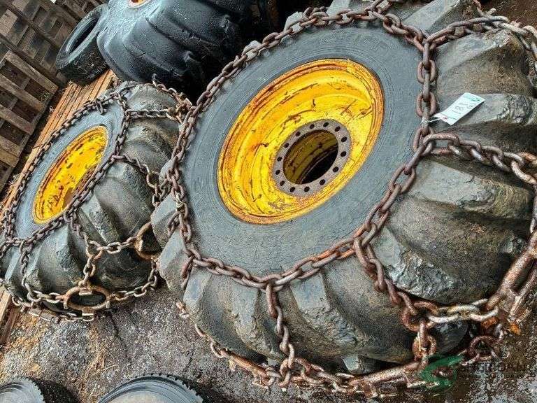2 Log skidder tires on rims with chains image
