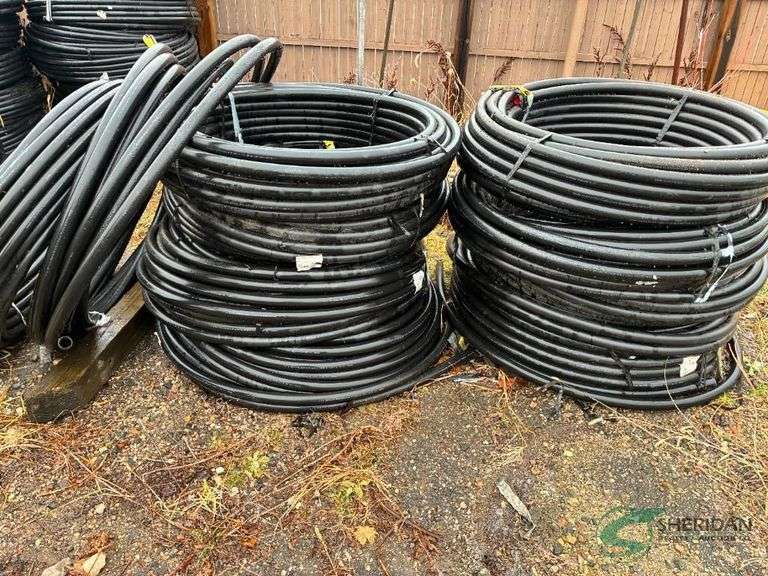 Numerous rolls of 1.5" irrigation pipe image