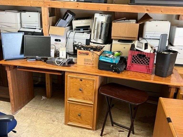 Desk, Computer Bag, Ink Cartridges, Box of Misc. Cords, Netgear Pro Safe JGS524pe 24-Port Switch, 2 APC Battery Backups, 3 Monitors, TV Tray, Milk Crate Full of Electronic Items, Trash Can with Misc. Items, Box of Hanging Folders, Working Condition Unknown
