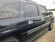 2004 Chevy Suburban - wrecked in the front * i have the key, motor runs good * front tire is messed up * north carolina title