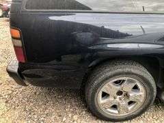2004 Chevy Suburban - wrecked in the front * i have the key, motor runs good * front tire is messed up * north carolina title