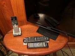 Flat screen TV, tall lamp and side table