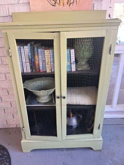 Sage Green Cabinet with Books, Decor, and Household Items image