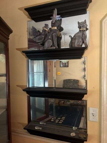 Mirrored wall shelves with contents