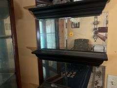 Mirrored wall shelves with contents