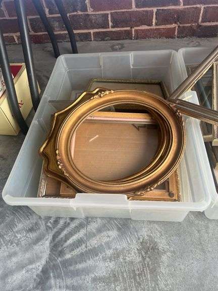 Three plastic containers full of miscellaneous picture frames