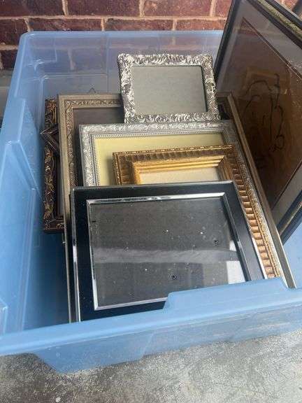Three plastic containers full of miscellaneous picture frames