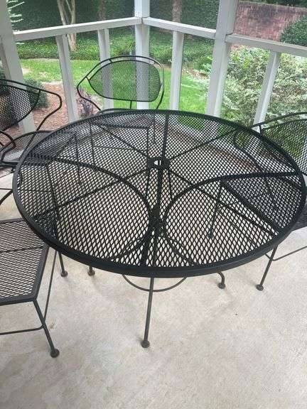 Wrought iron table with four chairs