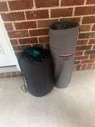 Two folding bag chairs in one bag and a sleeping bag.