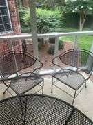Wrought iron table with four chairs