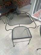 Wrought iron table with four chairs