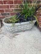 Oval concrete planter with basket pattern