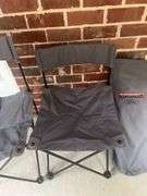 Two folding bag chairs in one bag and a sleeping bag.