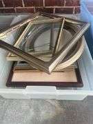 Three plastic containers full of miscellaneous picture frames