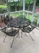 Wrought iron table with four chairs