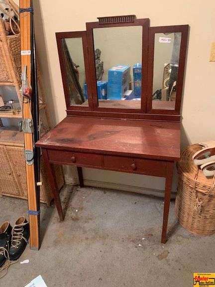 Vintage Wooden Vanity with a Three-Panel Mirror image