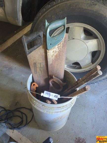 Bucket of Hand Saws and Wooden Handles