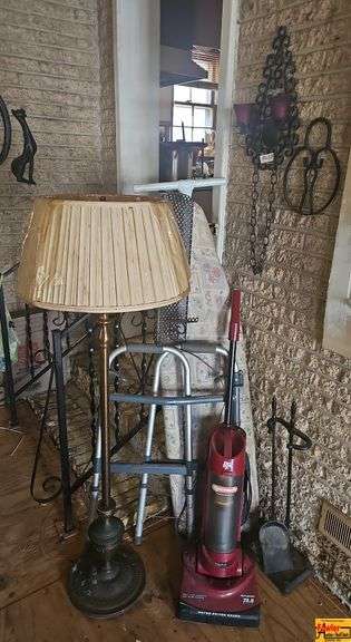 Stand Up Lamp, Ironing Board, Vacuum, Walker, and Wall Decor image