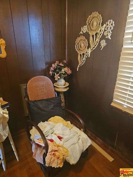 Cane Back Rocking Chair, Floral Wall Decor, and Side Table image